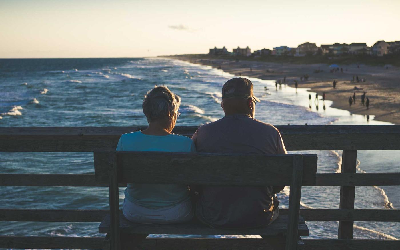 Old couple sitting on the beach